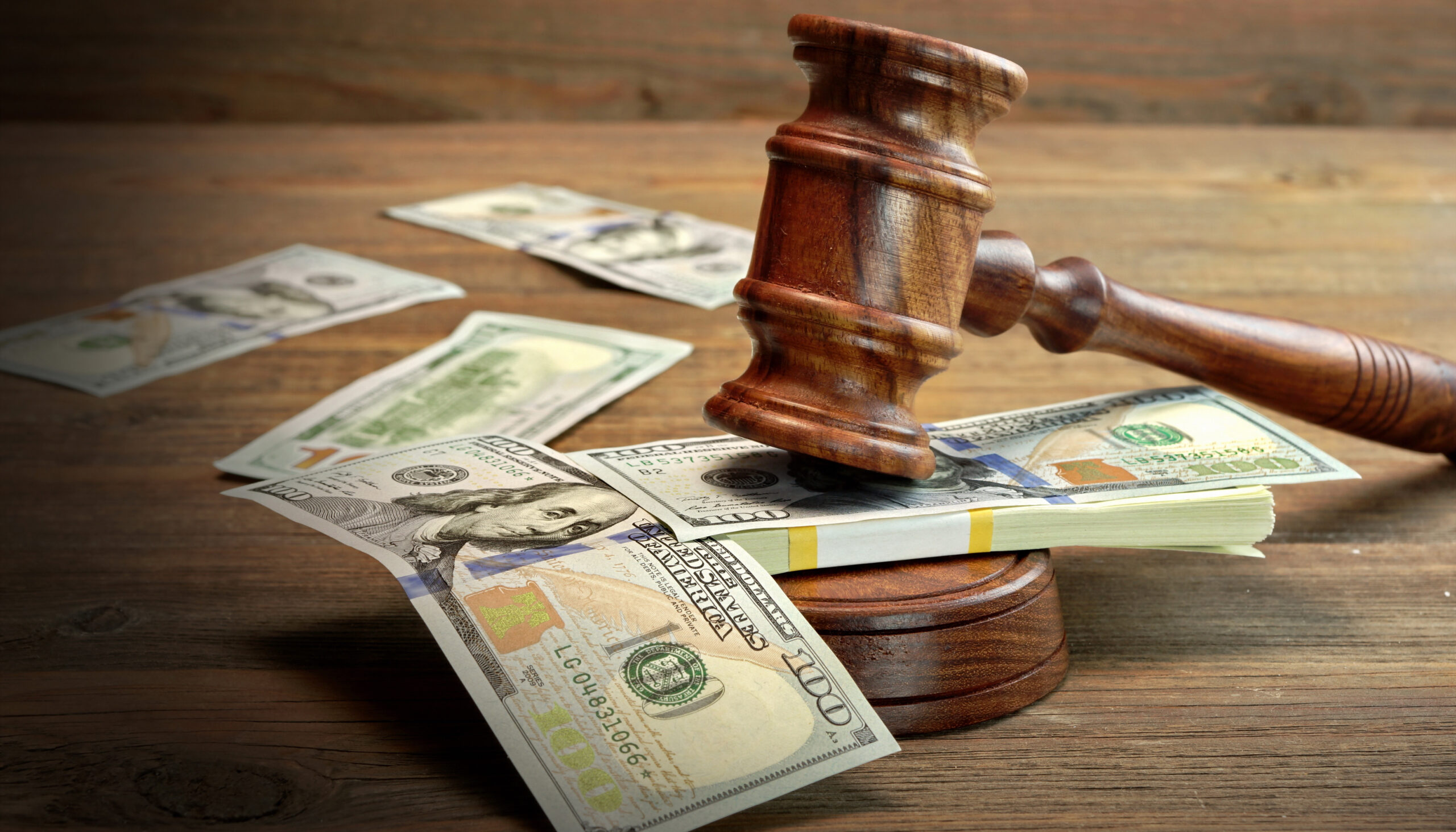 Concept For Corruption, Bankruptcy Court, Bail, Crime, Bribing, Fraud, Auction Bidding. Judges or Auctioneer Gavel, Soundboard And Bundle Of Dollar Cash On The Rough Wooden Textured Table Background.