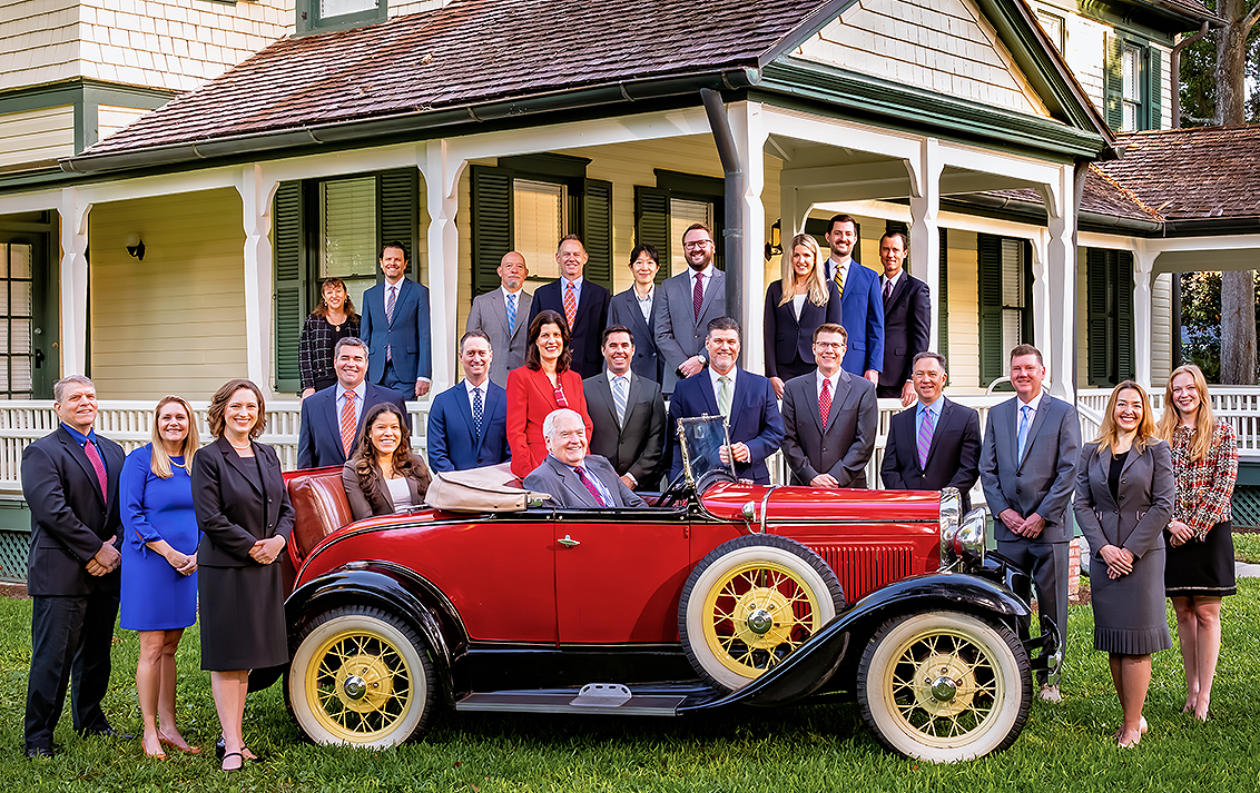 Winderweedle attorneys with a 1931 Model A Roadster, built the same year the firm was founded.