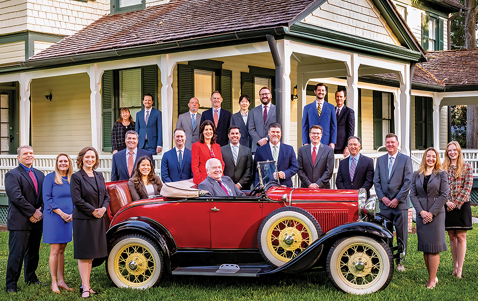 Winderweedle attorneys with a 1931 Model A Roadster, built the same year the firm was founded.